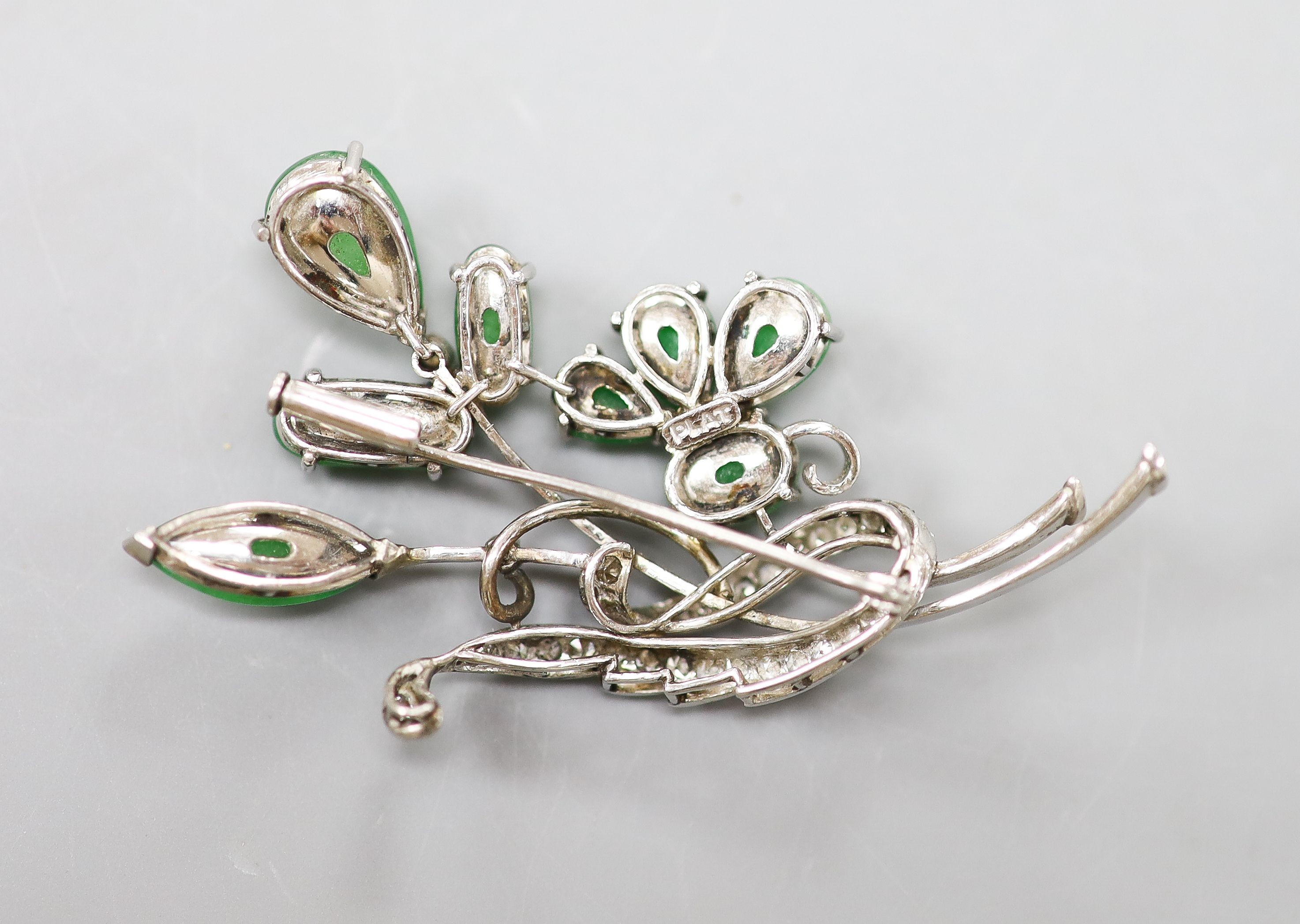 A white metal (stamped Plat), jade and diamond cluster set spray brooch, 50mm, gross weight 11.8 grams.